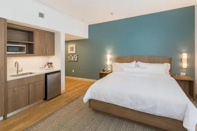 a large bedroom with a bed and a sink at Element Denver International Airport in Denver