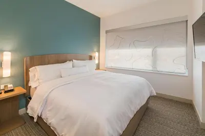 a bedroom with a large bed with a large window at Element Denver International Airport in Denver