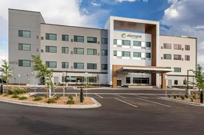 an office building with a parking lot in front of it at Element Denver International Airport in Denver