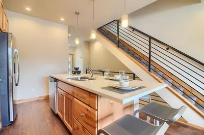 a kitchen with a sink and a staircase at Arrow at Winter Park Unit 286 in Winter Park