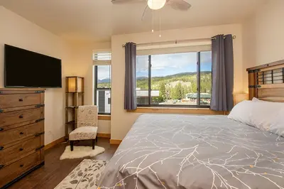 a bedroom with a bed and a tv and a window at Arrow at Winter Park Unit 286 in Winter Park