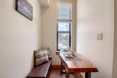 a dining room with a table and a bench and a window at Arrow at Winter Park Unit 286 in Winter Park
