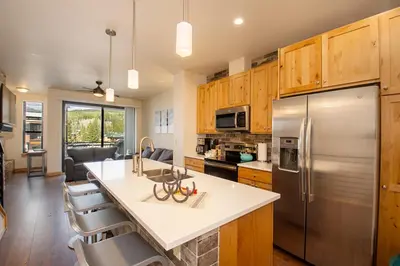 a kitchen with a stainless steel refrigerator and cabinets at Arrow at Winter Park Unit 286 in Winter Park
