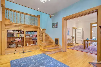 a living room with a staircase in a house at Stunning Historic Home - DT Location! - Sleeps 8 in Denver