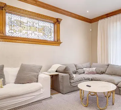 a living room with two couches and a stained glass window at Stunning Historic Home - DT Location! - Sleeps 8 in Denver