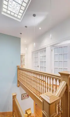 a staircase in a white room with pendant lights at Stunning Historic Home - DT Location! - Sleeps 8 in Denver