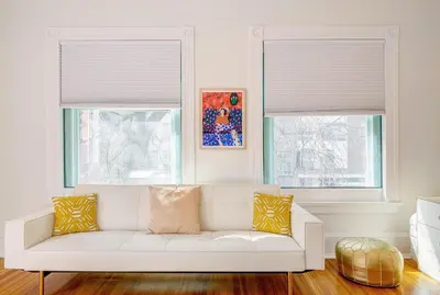a white couch in a living room with two windows at Stunning Historic Home - DT Location! - Sleeps 8 in Denver