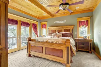 a bedroom with a bed and a wooden ceiling at Secluded & Spacious Mountain Getaway in Morrison
