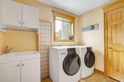 a laundry room with a washing machine and a sink at Secluded & Spacious Mountain Getaway in Morrison