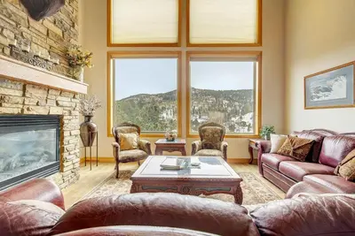 a living room with a couch and a fireplace at Secluded & Spacious Mountain Getaway in Morrison
