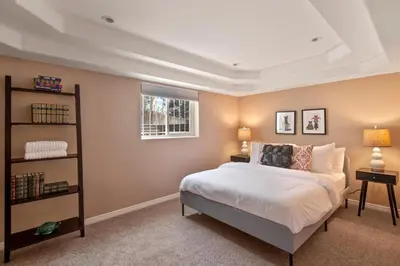a bedroom with a bed and a book shelf at Relaxing Escape + Large Deck - 12 Min to Red Rocks in Lakewood