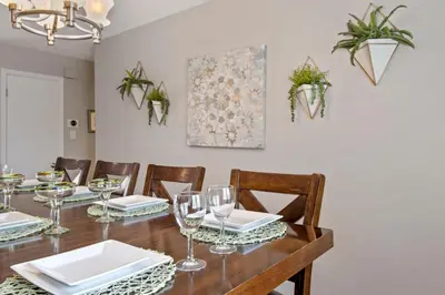 a dining room with a wooden table with wine glasses at Relaxing Escape + Large Deck - 12 Min to Red Rocks in Lakewood