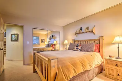 a bedroom with a large bed and a mirror at 10 Mi to Breckenridge Townhome with Hot Tub and Deck! in Frisco