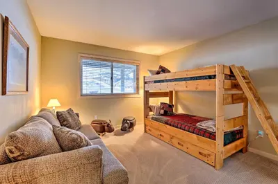 a living room with a bunk bed and a couch at 10 Mi to Breckenridge Townhome with Hot Tub and Deck! in Frisco