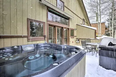 a large black tub sitting outside of a house at 10 Mi to Breckenridge Townhome with Hot Tub and Deck! in Frisco