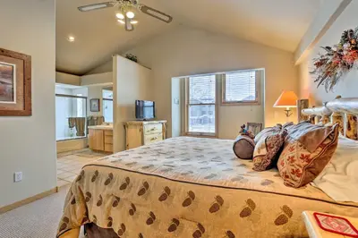 a bedroom with a large bed and a window at 10 Mi to Breckenridge Townhome with Hot Tub and Deck! in Frisco