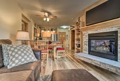 a living room with a couch and a fireplace at Premier 2 Bedroom Mountain Condo In River Run Village With Expansive Mountain Views And Walking Distance To Ski Slopes in Keystone
