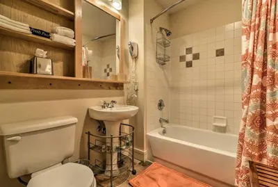 a bathroom with a toilet and a sink and a tub at Premier 2 Bedroom Mountain Condo In River Run Village With Expansive Mountain Views And Walking Distance To Ski Slopes in Keystone