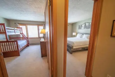 a room with a bedroom with a bed and a window at 2 Bedroom Mountain Condo In Lakeside Village Near Keystone Lake With Complimentary Shuttle Service in Keystone