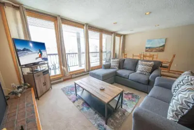 a living room with a couch and a table at 2 Bedroom Mountain Condo In Lakeside Village Near Keystone Lake With Complimentary Shuttle Service in Keystone