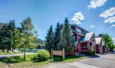 a red house with a sign in front of it at 2 Bedroom Mountain Condo In Lakeside Village Near Keystone Lake With Complimentary Shuttle Service in Keystone