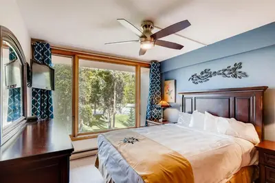 a bedroom with a large bed and a window at Lakeside Village 4 Bedroom Condo in Keystone