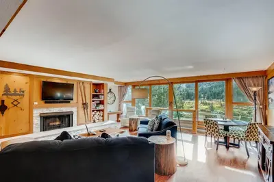 a living room with a couch and a fireplace at Lakeside Village 4 Bedroom Condo in Keystone