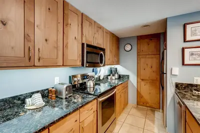 a kitchen with wooden cabinets and a counter top at Lakeside Village 4 Bedroom Condo in Keystone