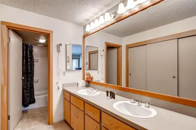 a bathroom with two sinks and a large mirror at Lakeside Village 4 Bedroom Condo in Keystone