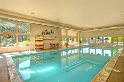 a large swimming pool in a large house at Lakeside Village 4 Bedroom Condo in Keystone