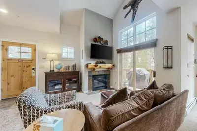 a living room with a leather couch and chairs at Seasons 3 Bedroom Townhome At Lakeside Village in Keystone