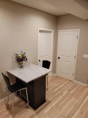 a room with a table and chairs and two doors at Jule Sleep in Denver