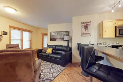a living room with a couch and a table and a kitchen at Tenderfoot Lodge 2 Bedroom In Keystone in Keystone