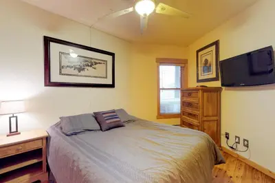 a bedroom with a bed and a flat screen tv at Tenderfoot Lodge 2 Bedroom In Keystone in Keystone