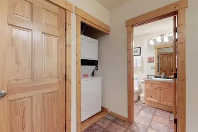 a kitchen with a door open to a kitchen with a refrigerator at Tenderfoot Lodge 2 Bedroom In Keystone in Keystone
