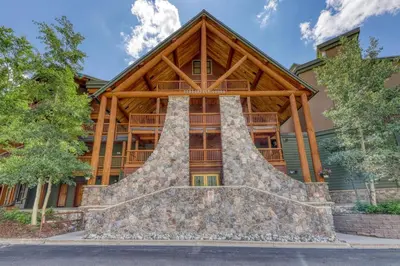 an image of a log home with a stone staircase in front at Tenderfoot Lodge 2 Bedroom In Keystone in Keystone