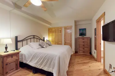 a bedroom with a bed with a television and a dresser at Tenderfoot Lodge 2 Bedroom In Keystone in Keystone