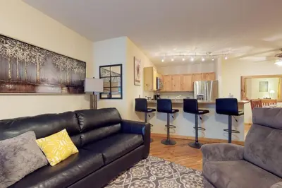 a living room with a couch and a kitchen at Tenderfoot Lodge 2 Bedroom In Keystone in Keystone