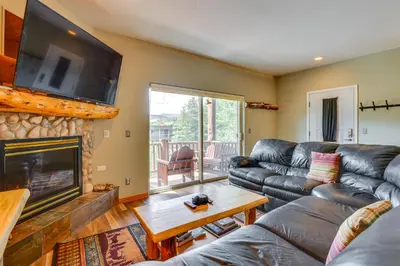 a living room with a couch and a fireplace at Cozy Condo with Views, 3 Mi to Winter Park Resort! in Winter Park