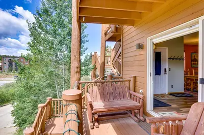 a porch with two wooden benches on a house at Cozy Condo with Views, 3 Mi to Winter Park Resort! in Winter Park