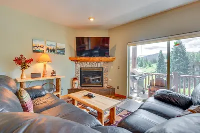 a living room with a couch and a fireplace at Cozy Condo with Views, 3 Mi to Winter Park Resort! in Winter Park