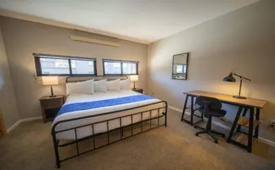 a bedroom with a bed and a desk with a desk at 1 Bedroom Mountain Condo In Lakeside Village Near Keystone Lake With Complimentary Shuttle Service in Keystone
