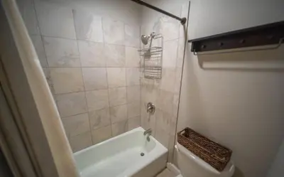a bathroom with a shower and a tub and a toilet at 1 Bedroom Mountain Condo In Lakeside Village Near Keystone Lake With Complimentary Shuttle Service in Keystone