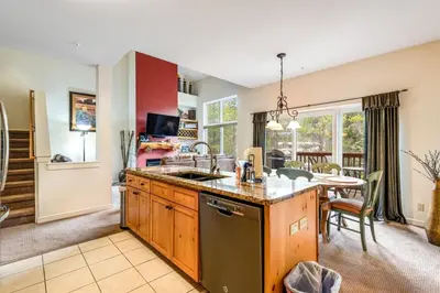 a kitchen with a sink and a table in a room at Luxury 3 Bedroom Townhouse Next To Keystone Lake, Free Shuttle, Hot Tub And Sauna in Keystone