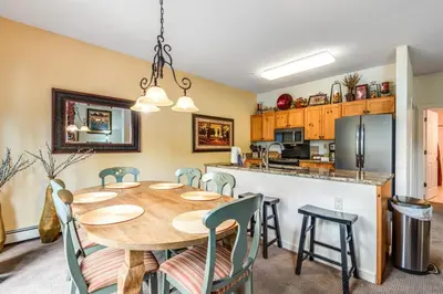 a kitchen and dining room with a table and chairs at Luxury 3 Bedroom Townhouse Next To Keystone Lake, Free Shuttle, Hot Tub And Sauna in Keystone