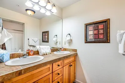 a bathroom with two sinks and a large mirror at Luxury 3 Bedroom Townhouse Next To Keystone Lake, Free Shuttle, Hot Tub And Sauna in Keystone