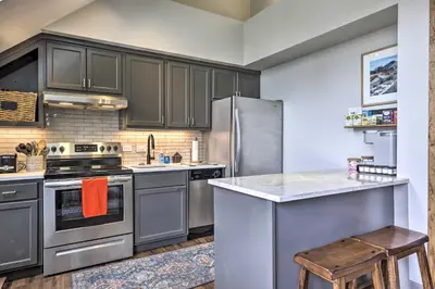a kitchen with gray cabinets and stainless steel appliances at Hot Tub and Ski Shuttle Access Keystone Condo! in Keystone