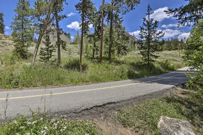 an empty road in a field with trees at Hot Tub and Ski Shuttle Access Keystone Condo! in Keystone