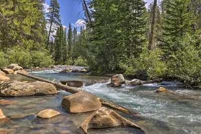 a stream of water with rocks and trees at Hot Tub and Ski Shuttle Access Keystone Condo! in Keystone