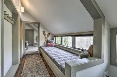 a hallway with a bed in a room with a window at Hot Tub and Ski Shuttle Access Keystone Condo! in Keystone